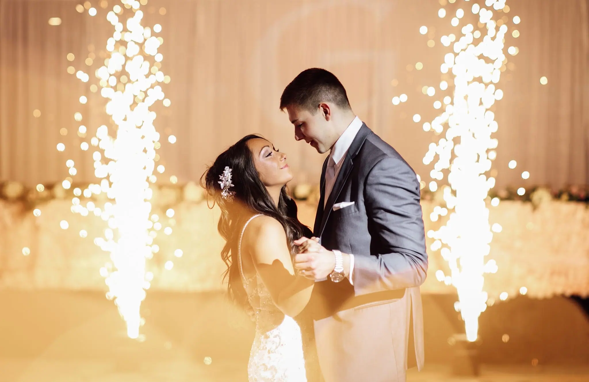 Newlyweds dance between two cold-spark fountains during their first dance